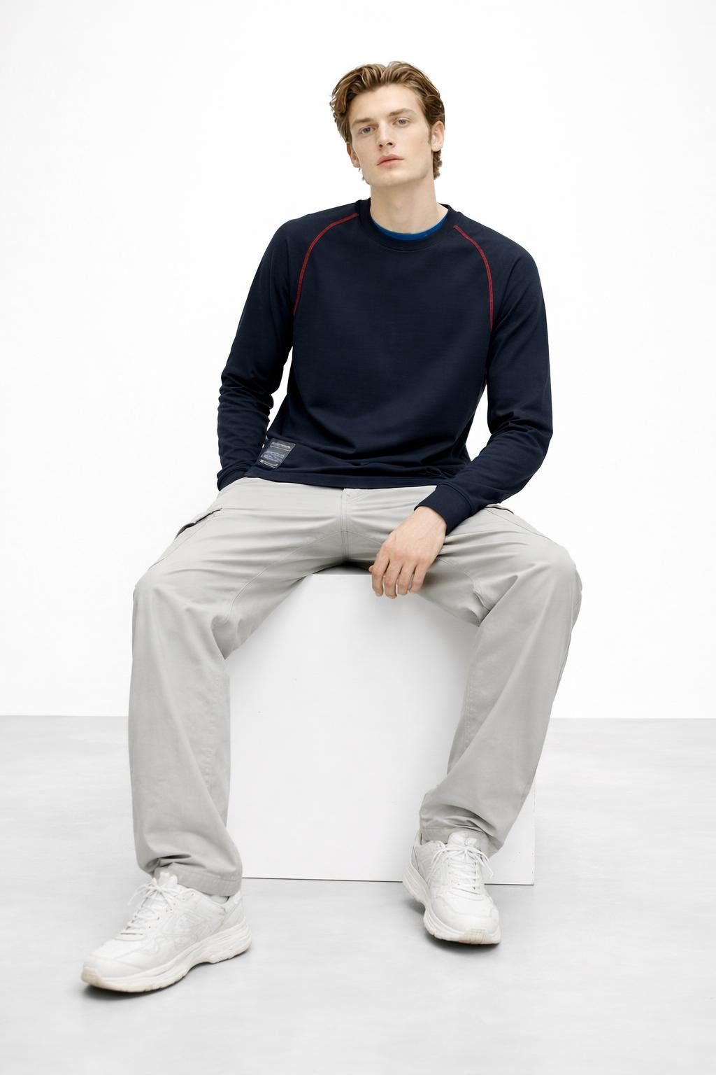 Model sitting while wearing Long Sleeves Knit